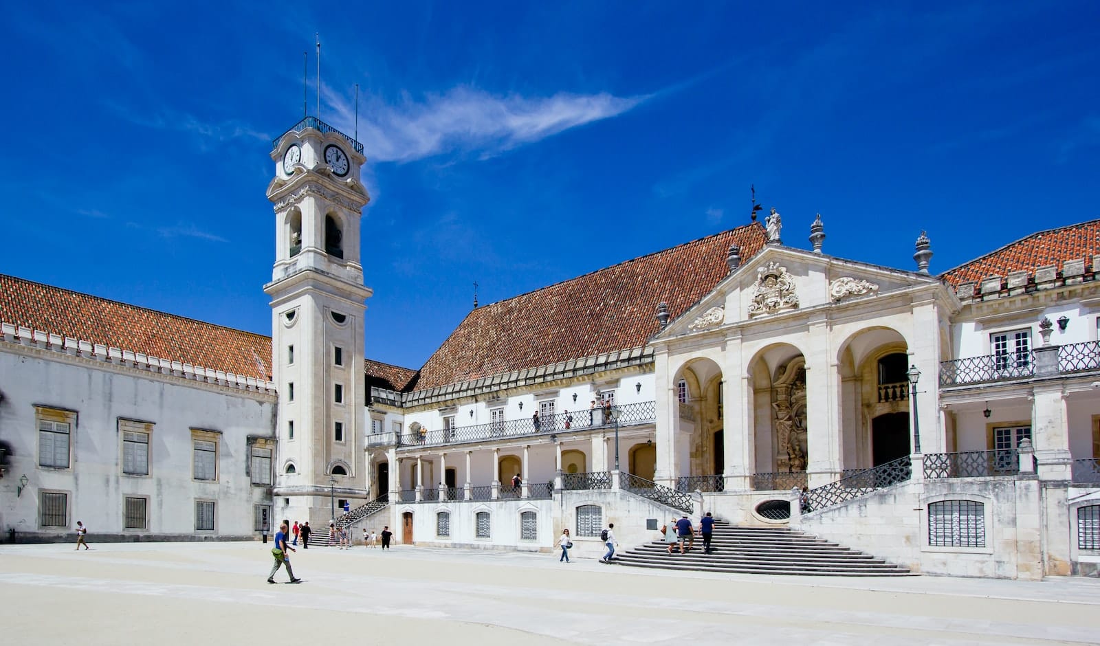 a large building with a clock tower in front of it
